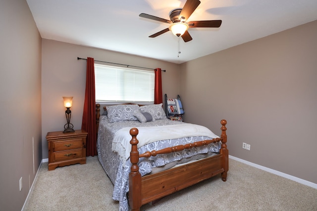 carpeted bedroom with a ceiling fan and baseboards