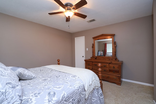 bedroom with ceiling fan, baseboards, visible vents, and light carpet