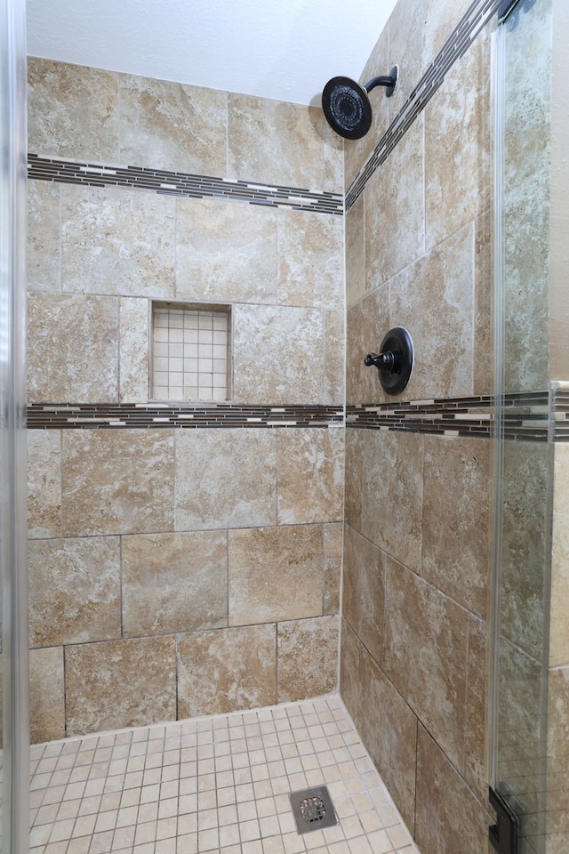 full bath featuring a shower stall