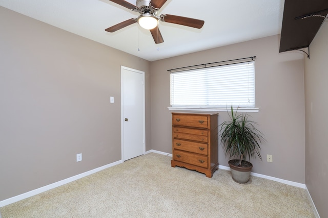 unfurnished bedroom featuring carpet flooring, baseboards, and ceiling fan