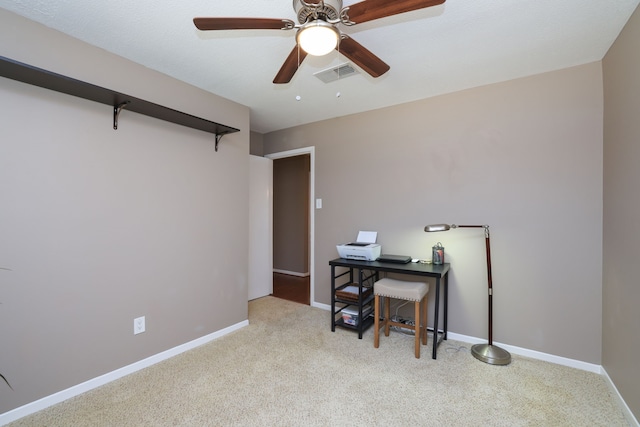 carpeted home office with visible vents, baseboards, and a ceiling fan