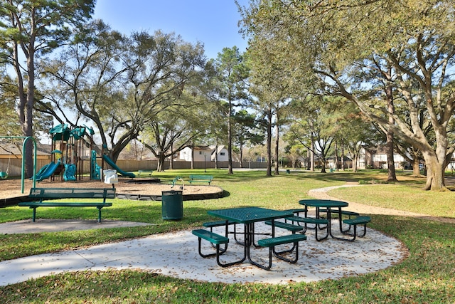 view of home's community with a lawn and playground community