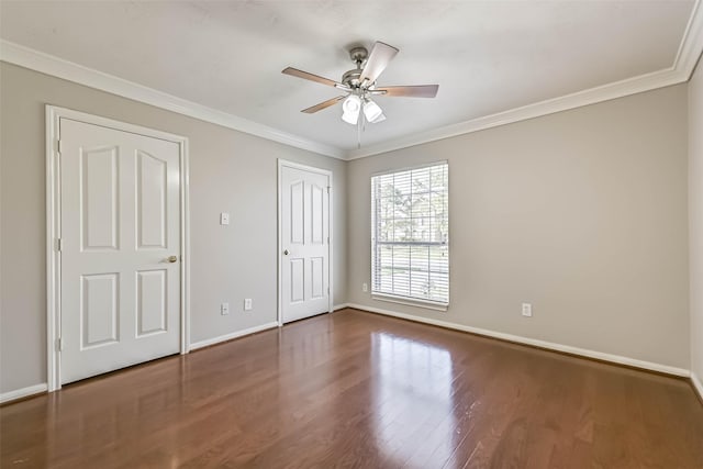 unfurnished bedroom featuring baseboards, a ceiling fan, wood finished floors, and crown molding