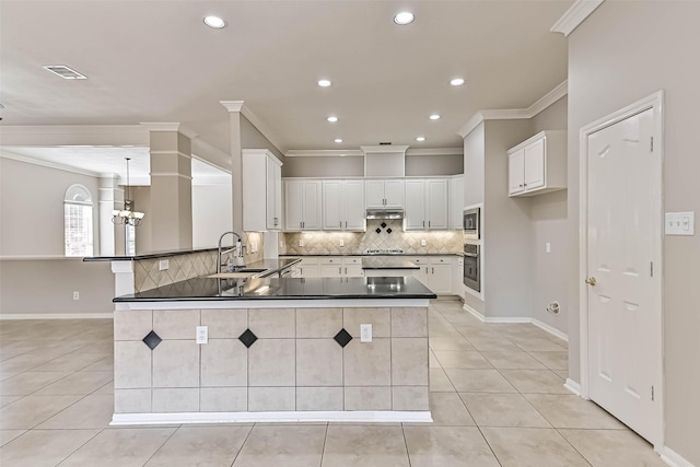 kitchen featuring a sink, stainless steel appliances, dark countertops, and light tile patterned flooring