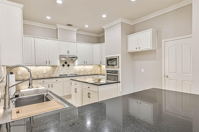 kitchen featuring a sink, ornamental molding, stainless steel appliances, white cabinets, and under cabinet range hood