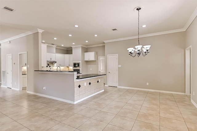 kitchen with visible vents, decorative backsplash, crown molding, appliances with stainless steel finishes, and dark countertops