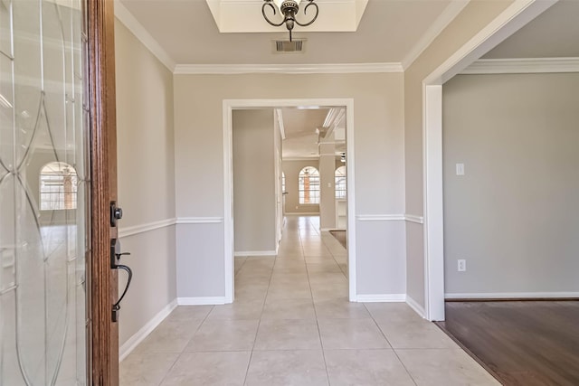 entryway featuring light tile patterned floors, visible vents, and ornamental molding