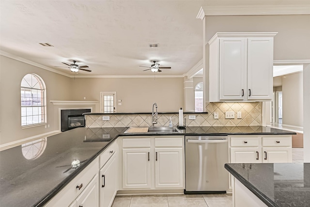 kitchen featuring visible vents, ornamental molding, a sink, stainless steel dishwasher, and backsplash