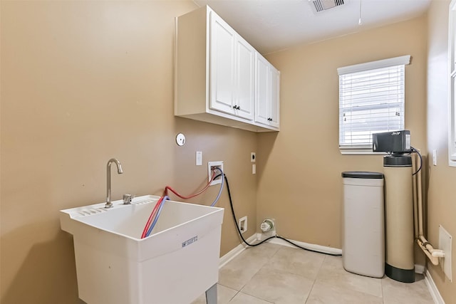 clothes washing area featuring light tile patterned floors, visible vents, cabinet space, electric dryer hookup, and washer hookup