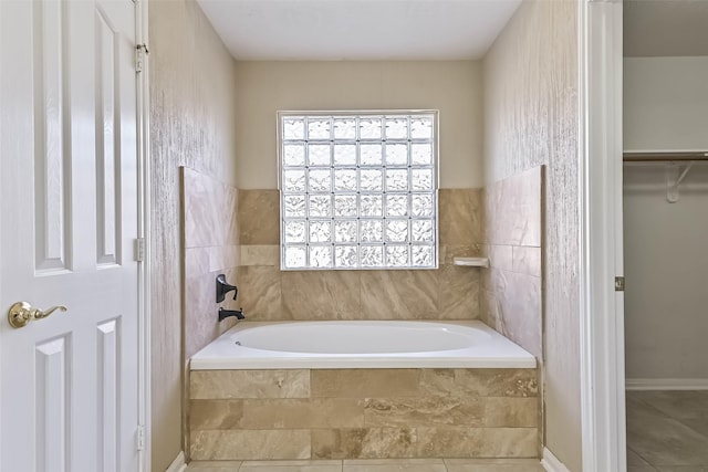 full bath with a bath, tile patterned flooring, and a walk in closet