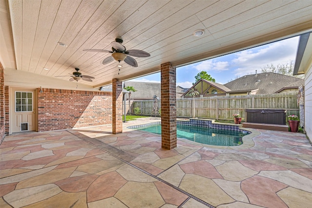 view of pool featuring a fenced backyard, a patio area, a fenced in pool, ceiling fan, and a hot tub