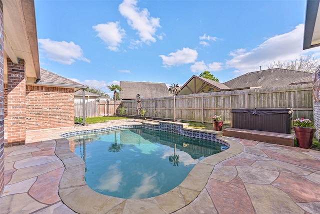 view of swimming pool with a patio area, a fenced in pool, a fenced backyard, and a hot tub