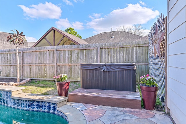 view of patio with fence, a pool, and a hot tub