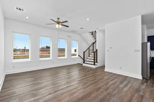 unfurnished living room with stairway, wood finished floors, visible vents, baseboards, and recessed lighting