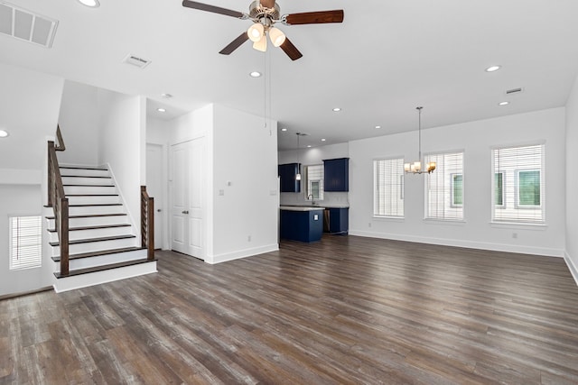 unfurnished living room with recessed lighting, visible vents, dark wood finished floors, and stairway