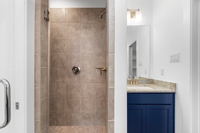 bathroom featuring vanity and a tile shower