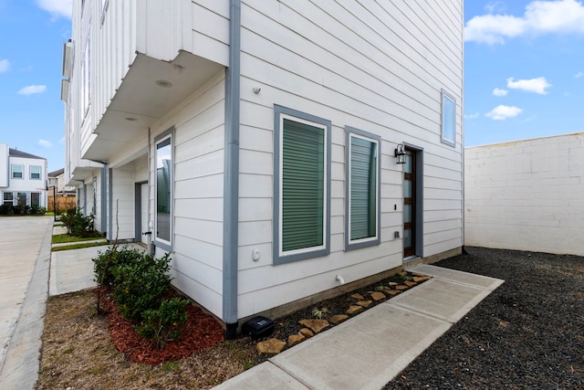 view of home's exterior with fence