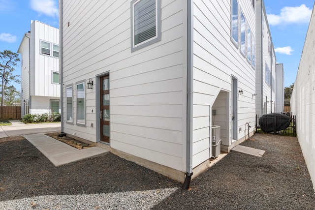 view of side of home featuring fence