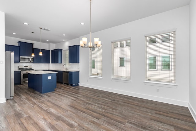 kitchen with a sink, visible vents, blue cabinetry, and appliances with stainless steel finishes