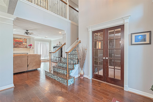 entrance foyer with french doors, stairs, a ceiling fan, and wood finished floors