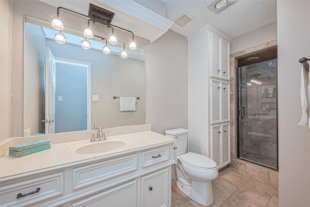 bathroom featuring vanity, visible vents, a shower stall, a textured ceiling, and toilet