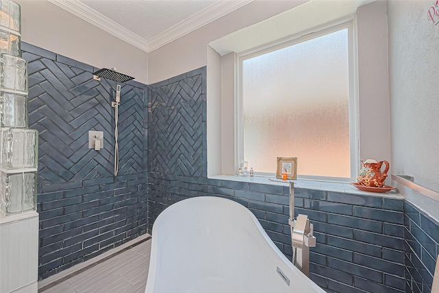 bathroom featuring a freestanding tub, walk in shower, a textured ceiling, crown molding, and tile walls