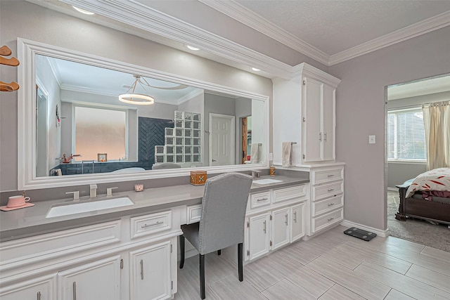 ensuite bathroom featuring double vanity, ornamental molding, connected bathroom, and a sink