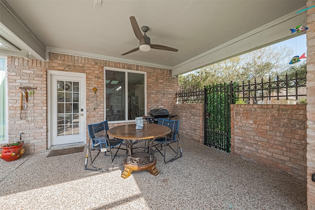 view of patio / terrace with fence, a grill, ceiling fan, and a gate