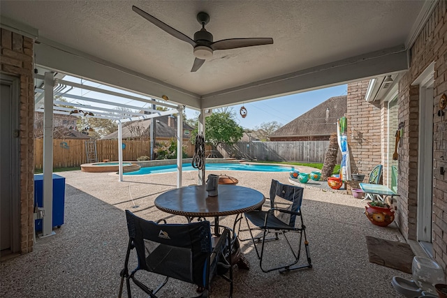 view of patio with ceiling fan, a fenced backyard, and a fenced in pool