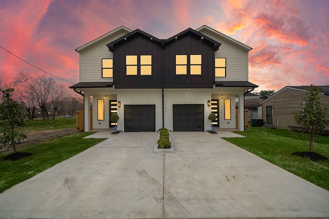 view of front of property with a front lawn, an attached garage, board and batten siding, and concrete driveway