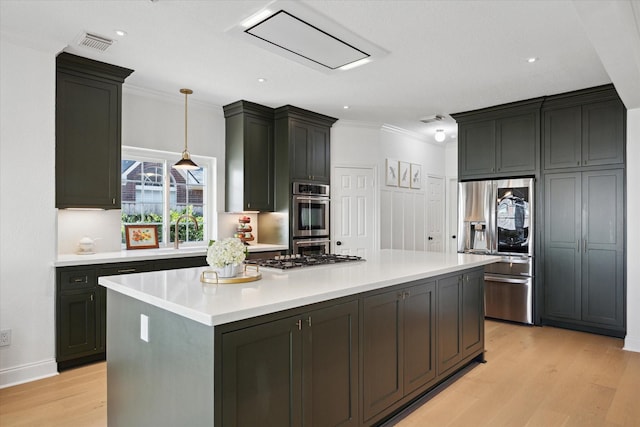 kitchen with visible vents, light wood-style flooring, a center island, appliances with stainless steel finishes, and light countertops