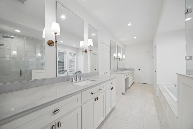 bathroom featuring a sink, two vanities, recessed lighting, and a shower stall