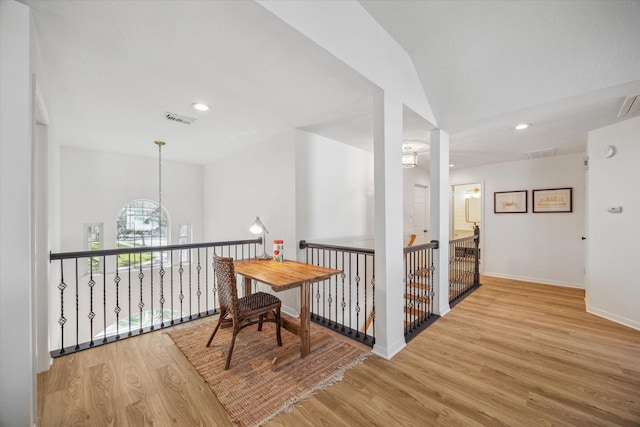 corridor with visible vents, baseboards, recessed lighting, wood finished floors, and a notable chandelier