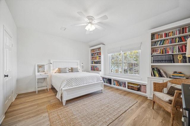 bedroom with a ceiling fan, baseboards, and light wood finished floors