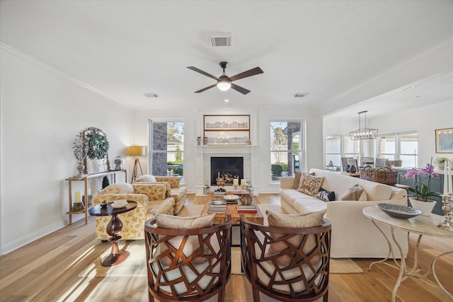 living area featuring light wood finished floors, visible vents, and a wealth of natural light