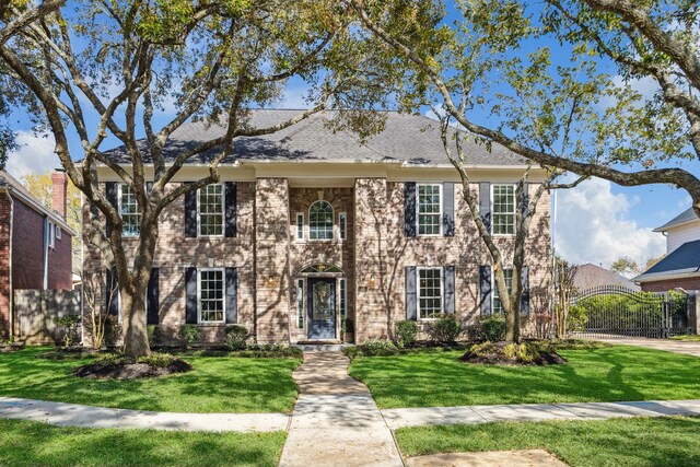 60 Bradford Cir, Sugar Land, TX 77479 - view of front facade with fence, a front lawn, and a gate