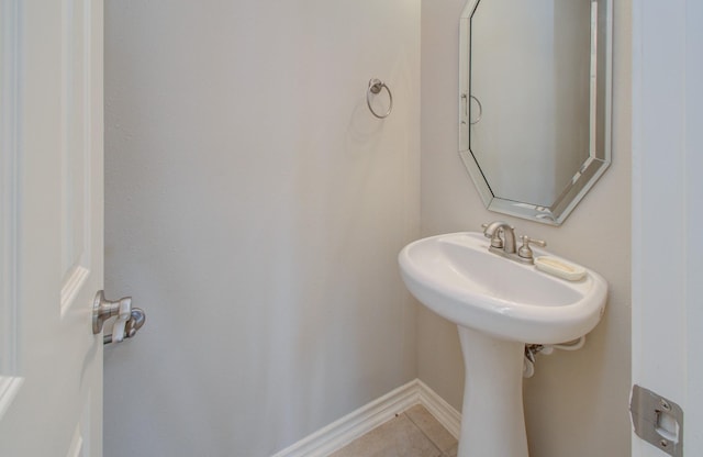 bathroom with tile patterned floors and baseboards