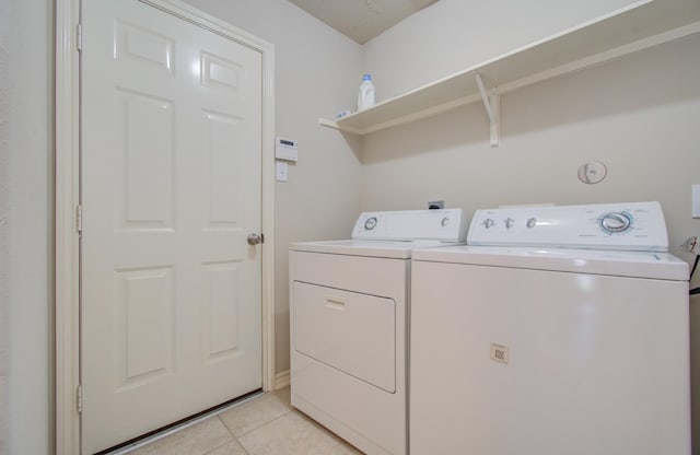 laundry area with light tile patterned floors, laundry area, and washer and dryer