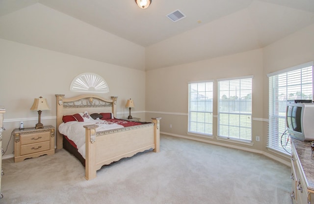 bedroom featuring lofted ceiling, baseboards, visible vents, and light carpet