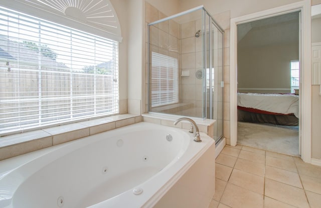 bathroom with tile patterned flooring, a tub with jets, a shower stall, and connected bathroom