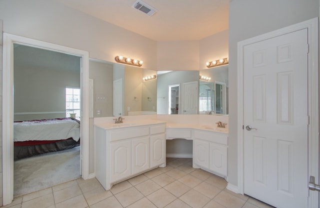 bathroom with tile patterned floors, visible vents, a sink, ensuite bath, and double vanity