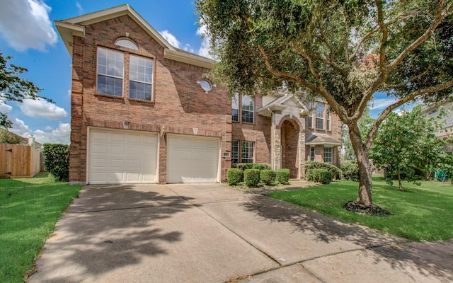 traditional home featuring brick siding, a front lawn, fence, concrete driveway, and a garage