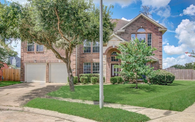 traditional home with driveway, brick siding, a front lawn, and fence