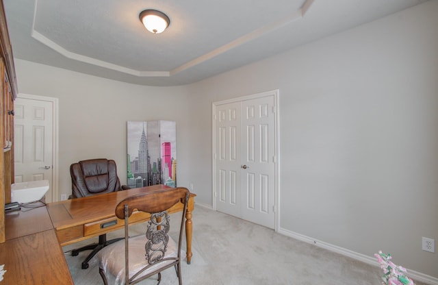 office with light carpet, baseboards, and a tray ceiling