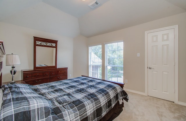 carpeted bedroom with vaulted ceiling, baseboards, and visible vents