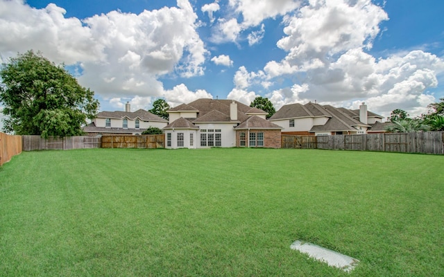 view of yard with a fenced backyard