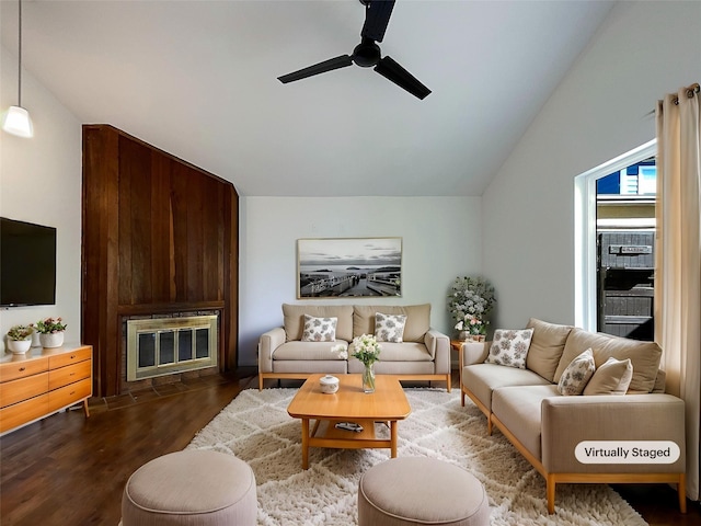 living area featuring ceiling fan, wood finished floors, a fireplace, and vaulted ceiling