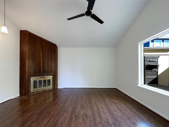 unfurnished living room featuring wood finished floors, baseboards, a large fireplace, lofted ceiling, and ceiling fan