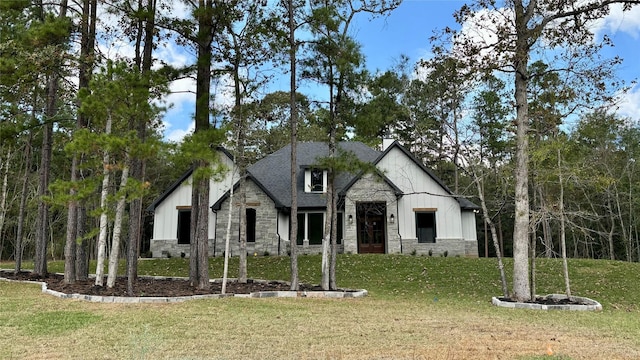 view of front of house with a front yard and stone siding