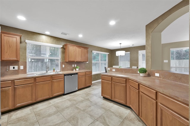 kitchen with dishwasher, light countertops, decorative backsplash, recessed lighting, and a sink